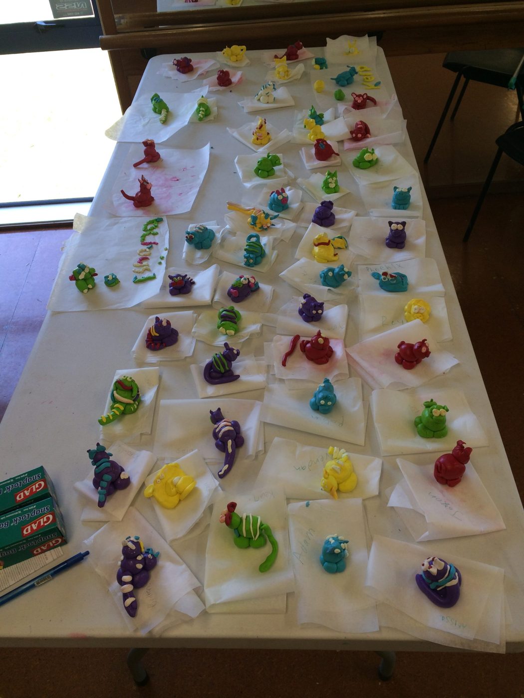 A workshop table covered in children's clay creations